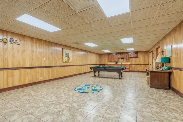 a view of a house with swimming pool and sitting area