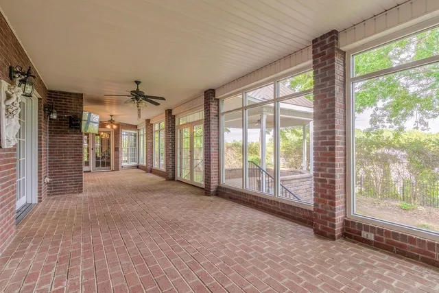 a view of a house with a yard and sitting area