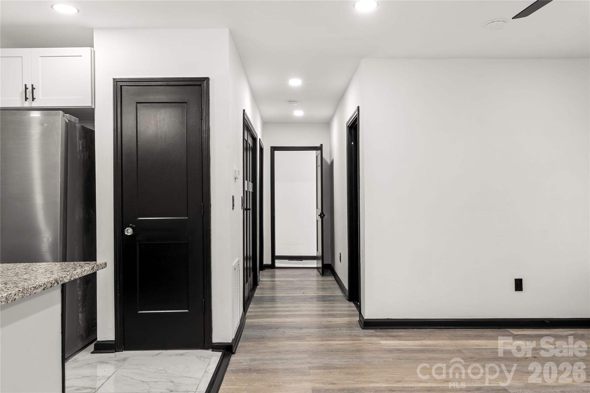 110 Courtland Street Chester, SC 29706 - Photo 8 of 22 a view of a hallway with wooden floor and staircase
