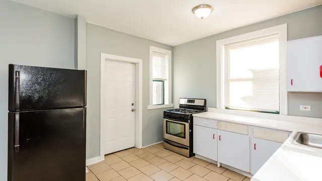 a kitchen with a refrigerator and a sink