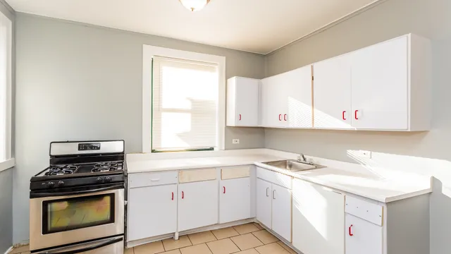 a kitchen with a stove a sink and a microwave