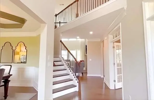 a view of entryway and hall with wooden floor