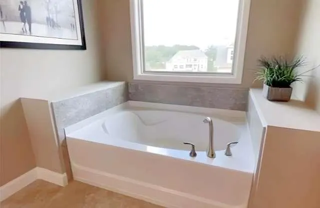 a bath tub sitting in a bathroom next to a window