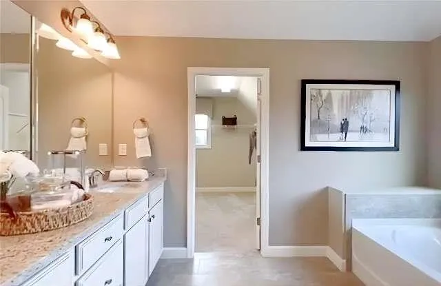 a bathroom with a double vanity sink and a mirror