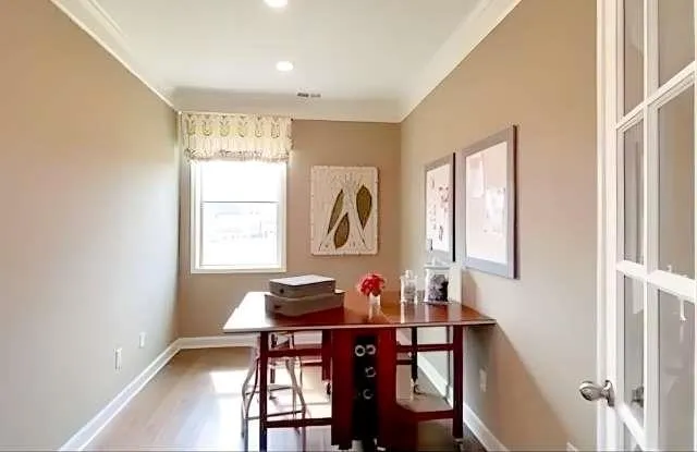 a dining room with furniture and window