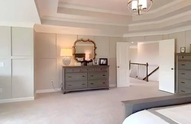 a bedroom with a bed and a dresser