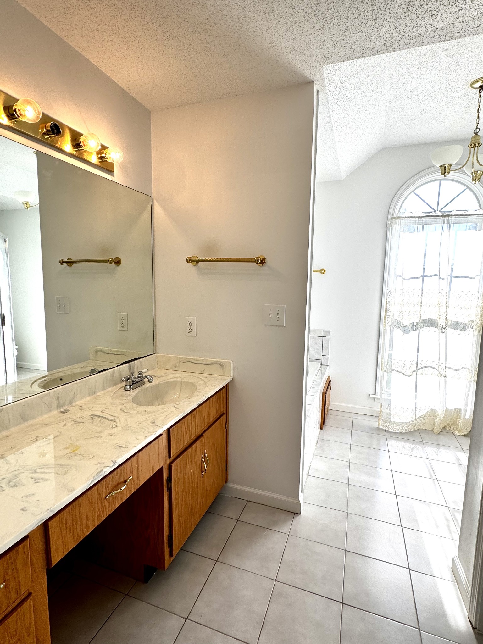 4207 Station Road Cunningham, TN 37052 - Photo 10 of 36 a bathroom with a granite countertop sink a mirror and a shower