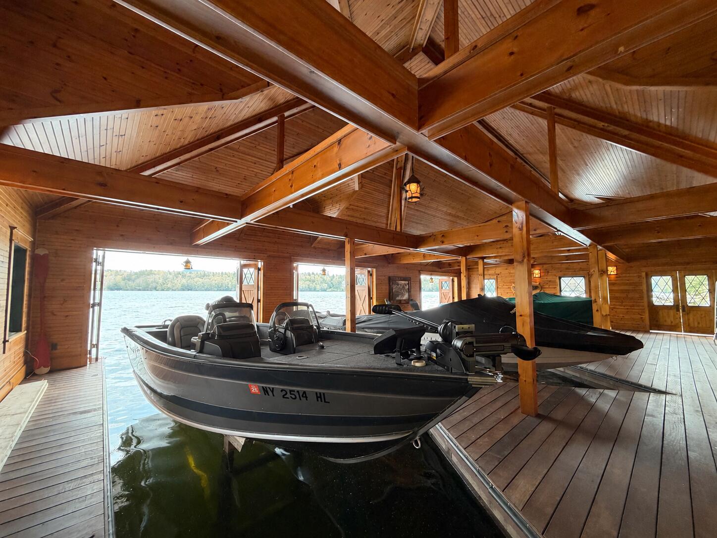 225 West Shore Road Saranac Lake, NY 12983 - Photo 5 of 71 This photo is AI modified to depict the boats in the boathouse based on early season ability to shoot.