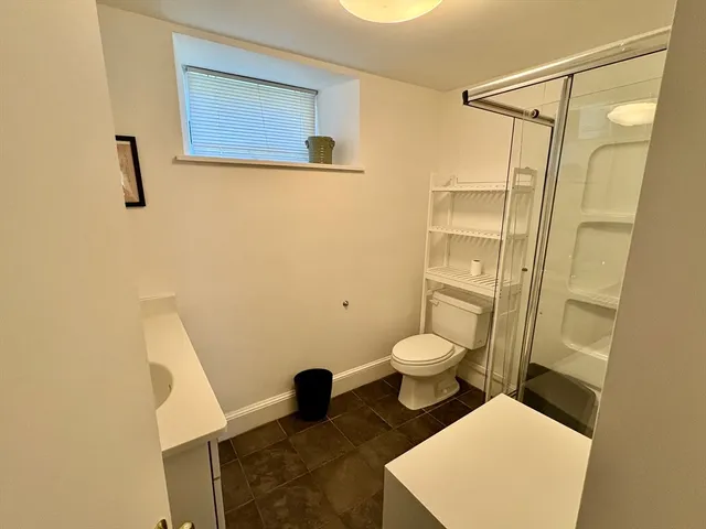 a bathroom with a toilet and a shower