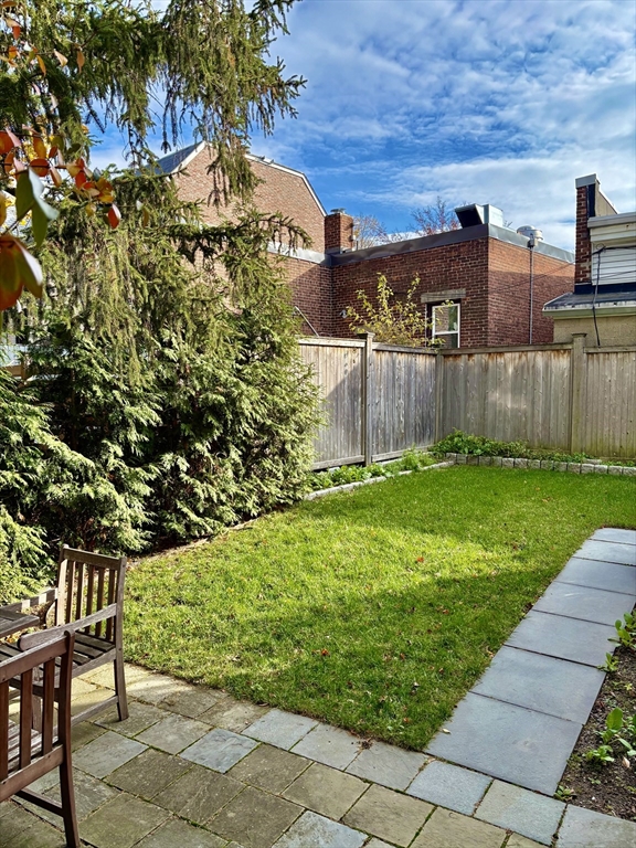 7 Standish Street, Unit 7 Cambridge, MA 02138 - Photo 15 of 16 a view of backyard with barbeque grill and wooden fence