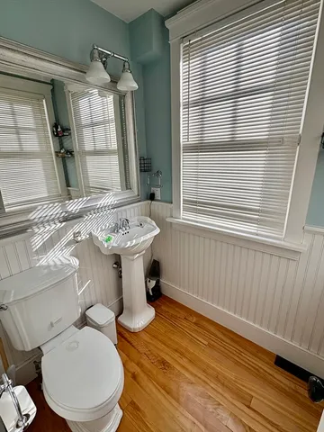 a bathroom with a sink toilet and window