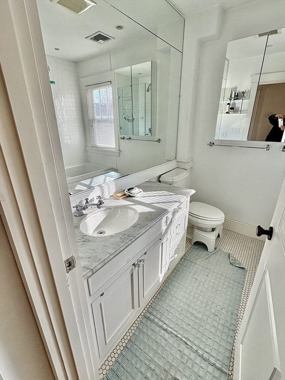 7 Standish Street, Unit 7 Cambridge, MA 02138 - Photo 9 of 16 a bathroom with a sink a toilet and mirror
