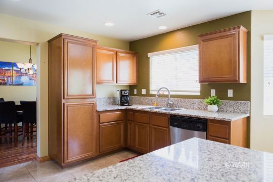 1129 Rebecca Avenue Ridgecrest, CA 93555 - Photo 12 of 34 a kitchen with stainless steel appliances granite countertop a sink stove and refrigerator