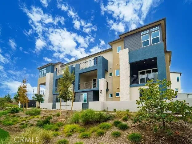 a front view of house with a garden