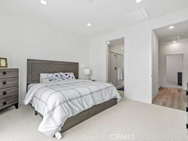 a bedroom with a bed and a mirror