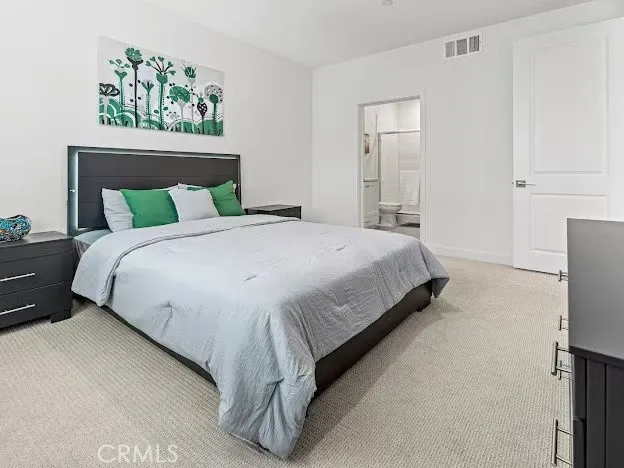 a large bed sitting in a bedroom and a table