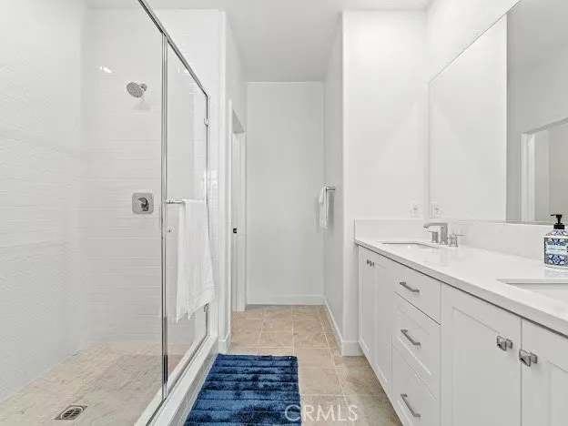 a bathroom with a double vanity sink and a shower