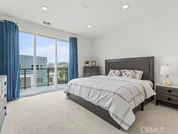 a bedroom with a bed and a couch