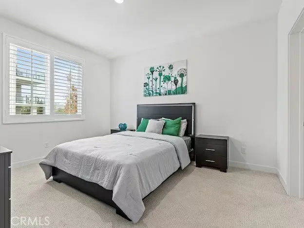 a kitchen with white cabinets and appliances