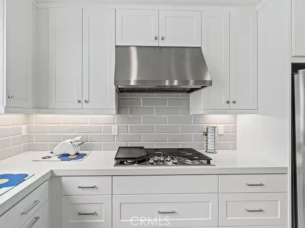 an empty room with wooden floor and window