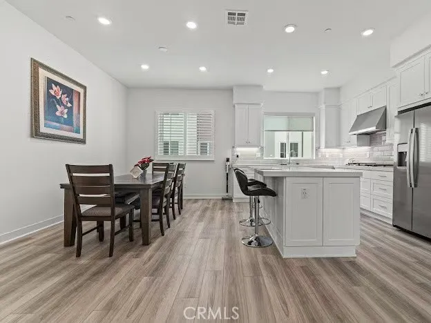 a view of kitchen with cabinets table and chairs