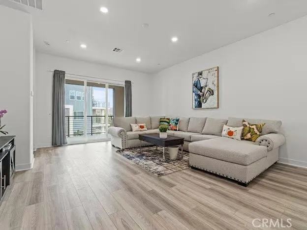 a living room with furniture and a floor to ceiling window