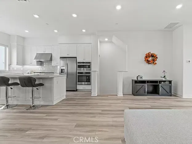 a kitchen with stainless steel appliances kitchen island granite countertop a sink and cabinets