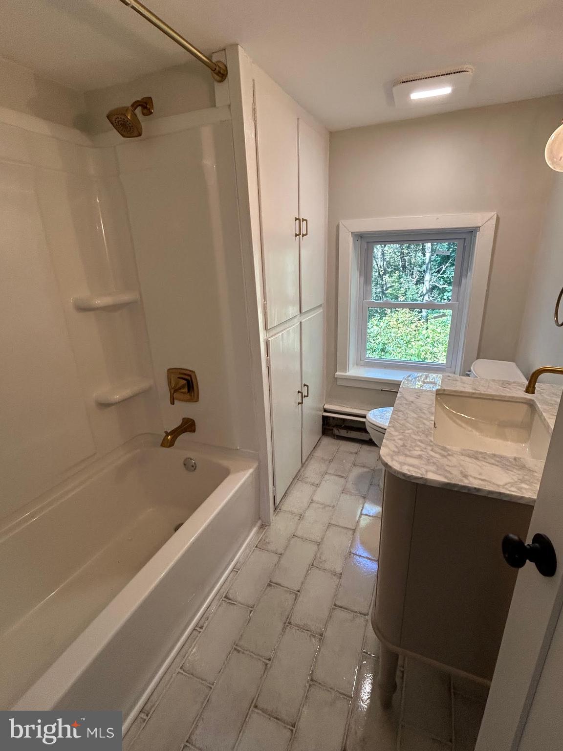 1355 Penn Grant Road, Unit 1 Strasburg, PA 17579 - Photo 12 of 14 a bathroom with a granite countertop sink a toilet and bathtub