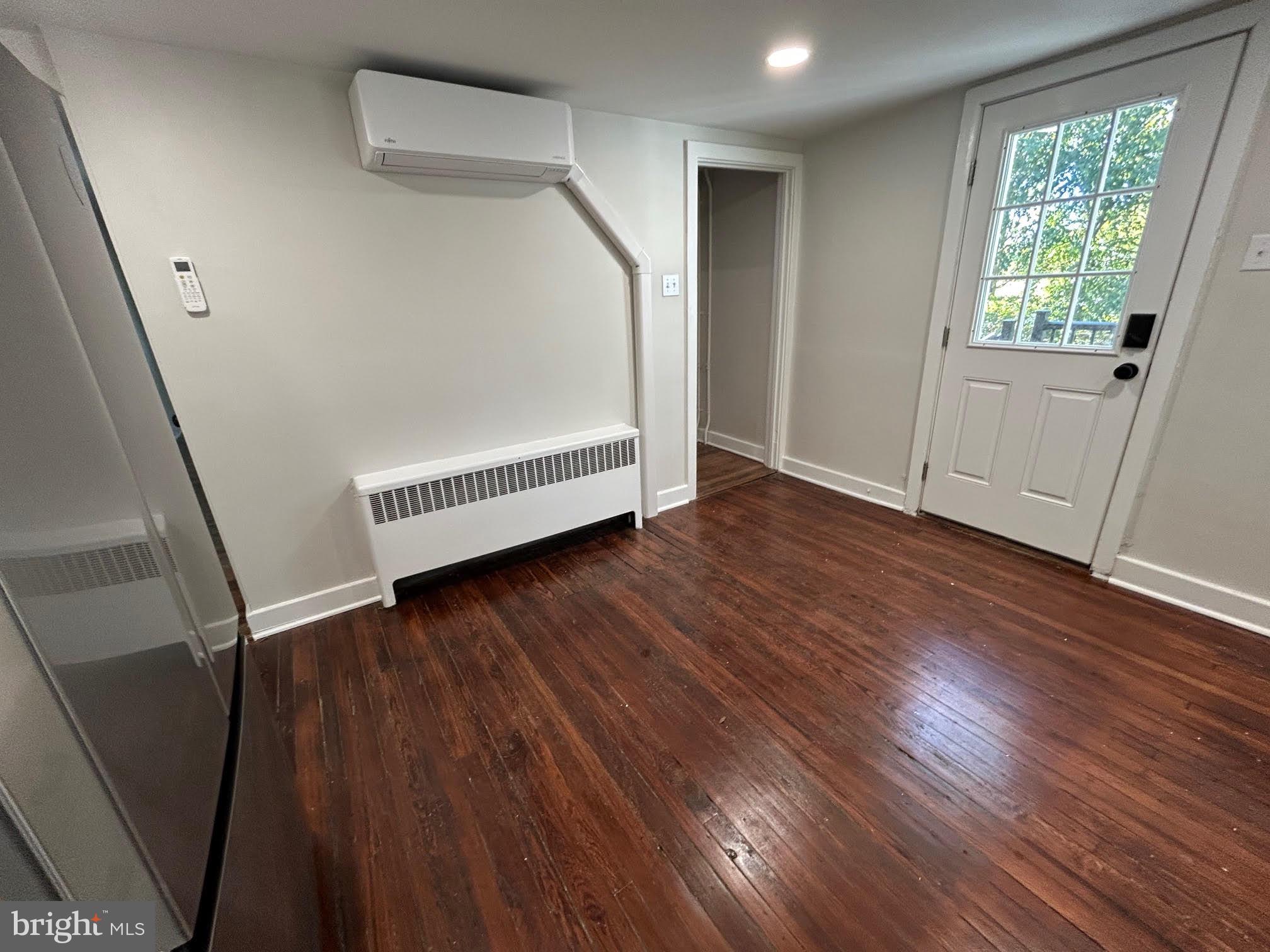 1355 Penn Grant Road, Unit 1 Strasburg, PA 17579 - Photo 3 of 14 an empty room with wooden floor and windows