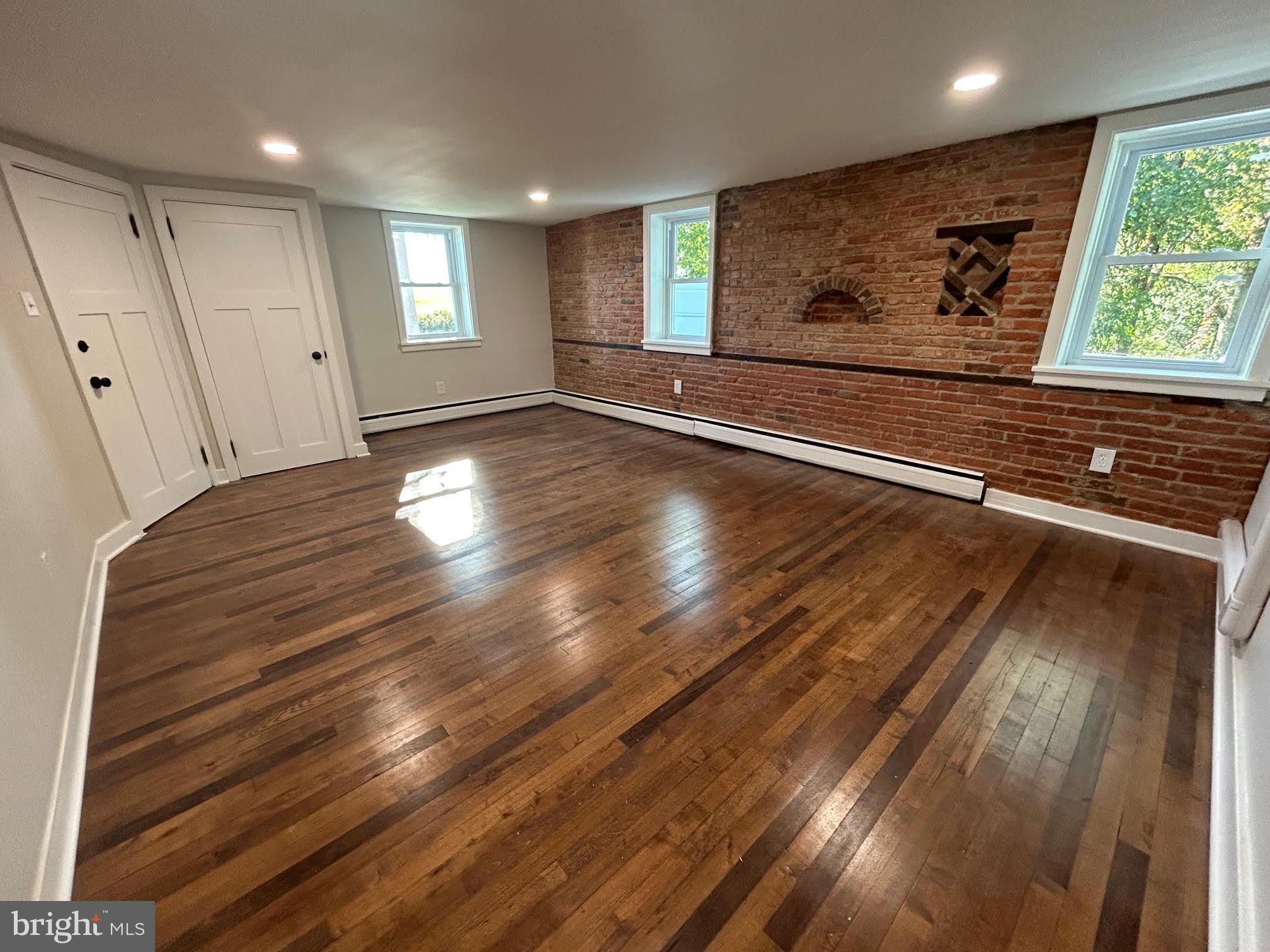 1355 Penn Grant Road, Unit 1 Strasburg, PA 17579 - Photo 4 of 14 a view of an empty room with wooden floor and a window