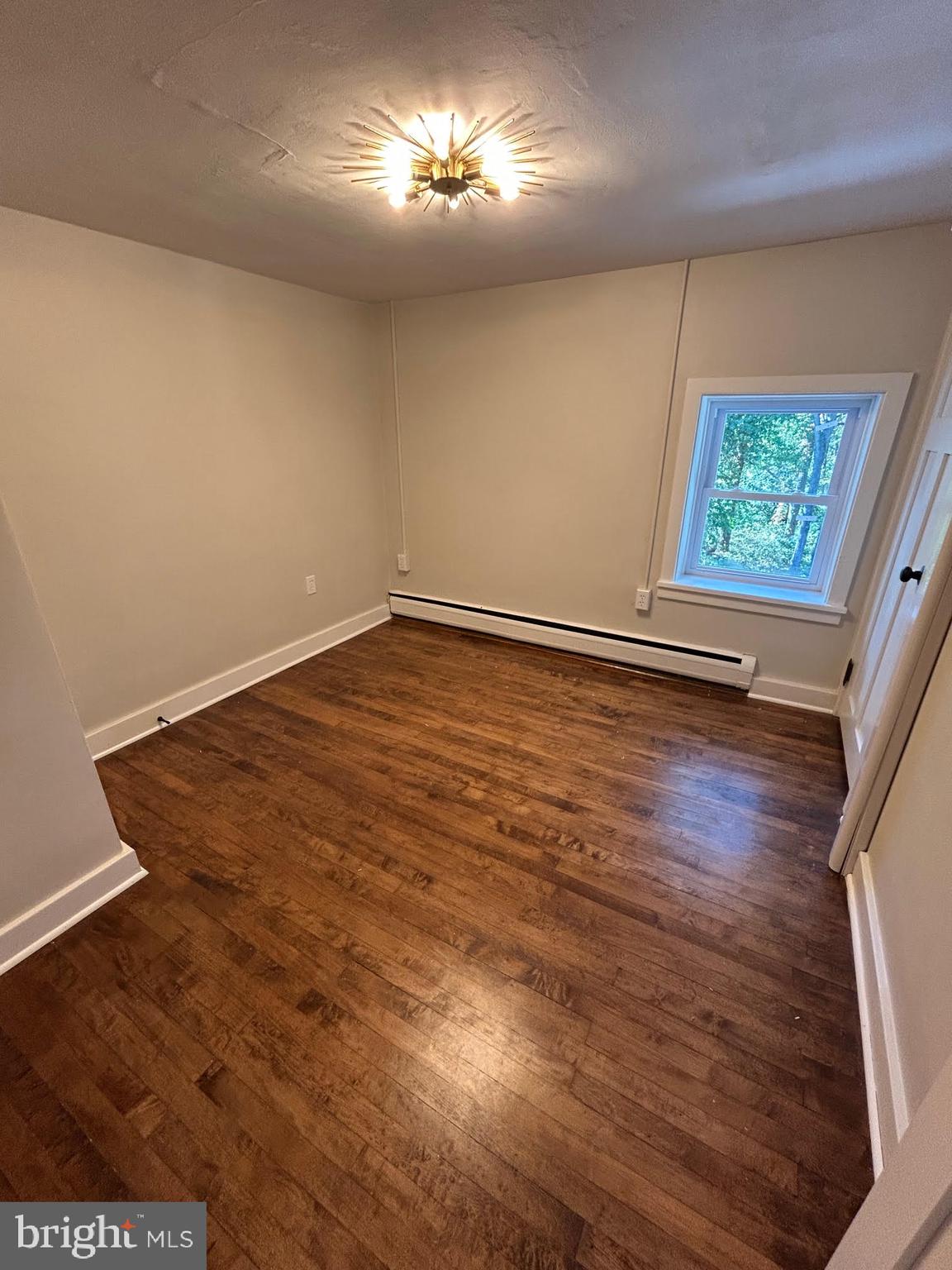 1355 Penn Grant Road, Unit 1 Strasburg, PA 17579 - Photo 8 of 14 wooden floor in an empty room with a window