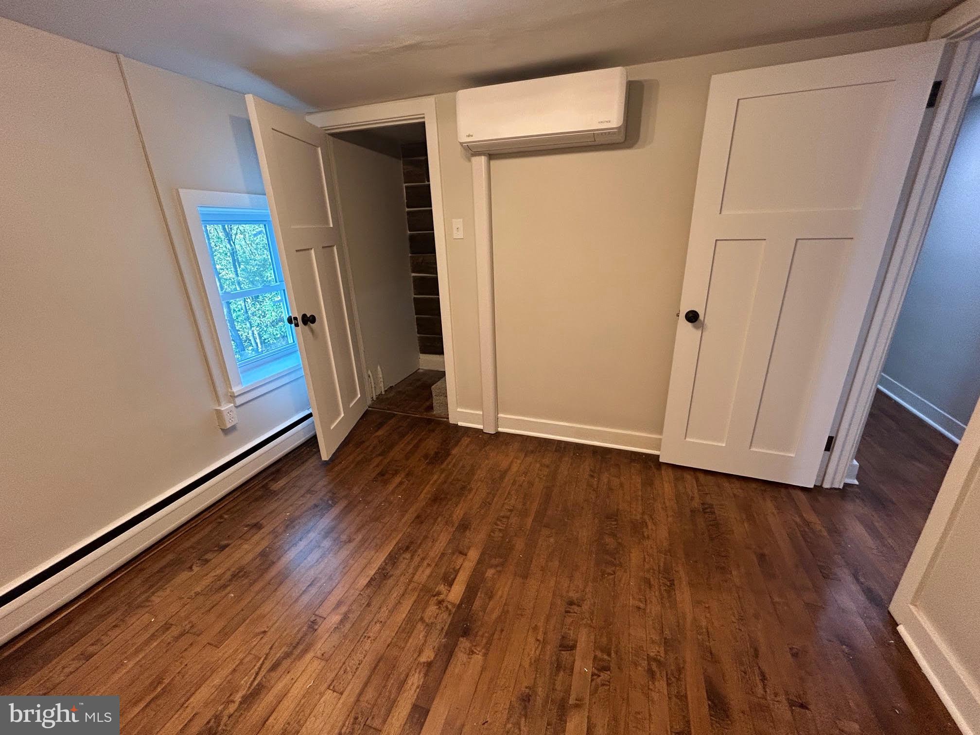 1355 Penn Grant Road, Unit 1 Strasburg, PA 17579 - Photo 9 of 14 a view of an empty room with wooden floor and a window
