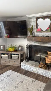 a living room with furniture flat screen tv and a fireplace
