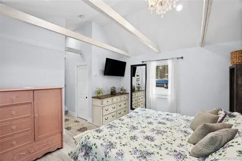 a living room with a bed and a dresser