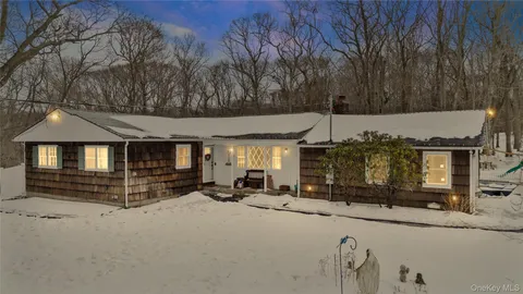 a view of the terrace with chairs and a fire pit
