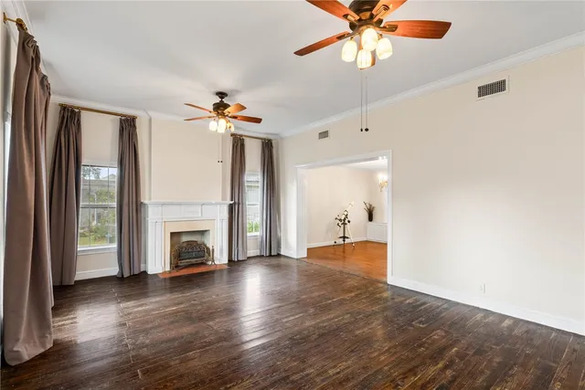 a view of an empty room with a fireplace and a window