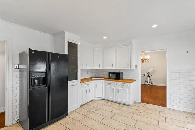 a kitchen with granite countertop a refrigerator and a sink