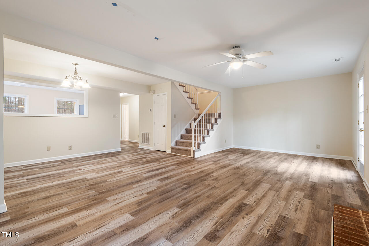 1501 Clermont Road, Unit T4 Durham, NC 27713 - Photo 8 of 29 an empty room with wooden floor fan and windows