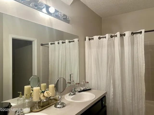 a bathroom with a double vanity sink and a mirror