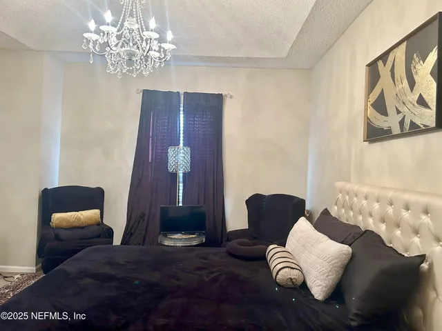 a living room with furniture and a chandelier