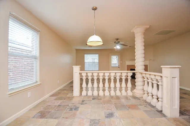 a view of a hallway with windows