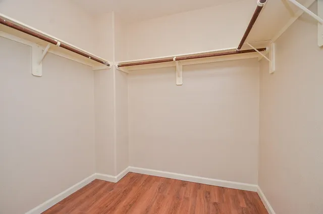 a view of a room with wooden floor