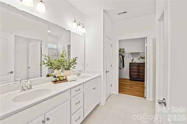 a bathroom with a sink double vanity and a mirror