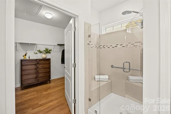 a view of walk in closet with clothes