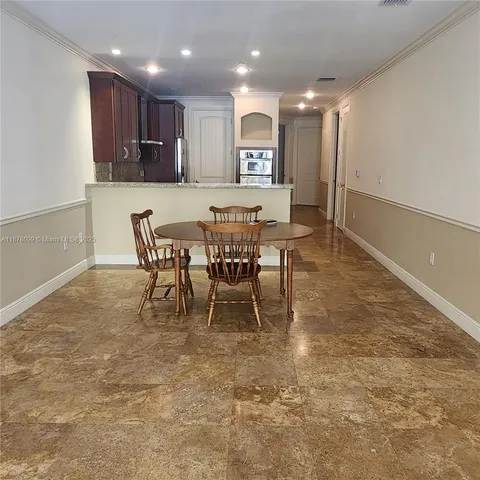 a room with a wooden floor and white wall