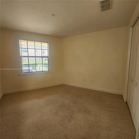 a view of an empty room and a window