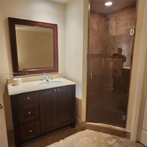 a bathroom with a granite countertop sink mirror and