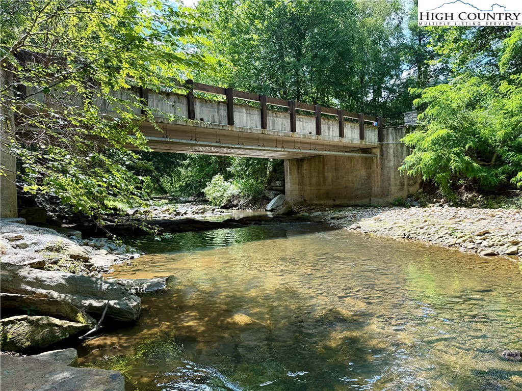 Lot 201 Twin Rivers Drive Boone, NC 28607 - Photo 14 of 14 a front view of a house with a yard and potted plants