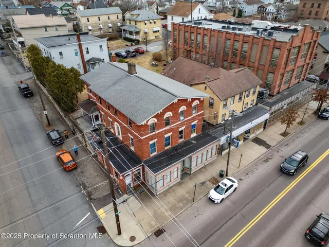 an aerial view of a house with roof deck outdoor seating and city view
