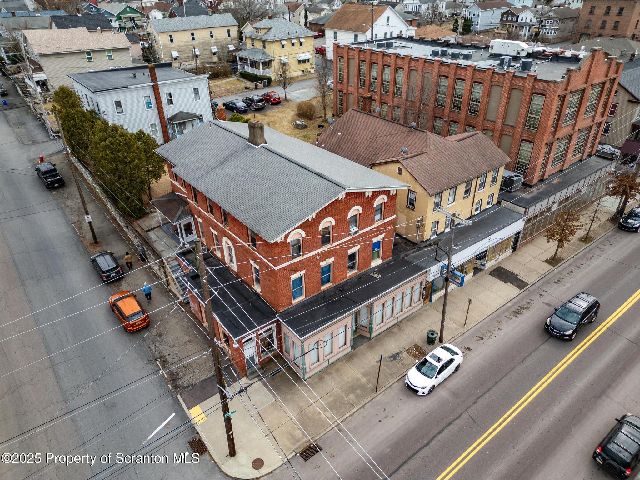 501-503 Cedar Avenue Scranton, PA 18505 - Photo 3 of 13 an aerial view of a house with roof deck outdoor seating and city view